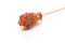 Brown sugar crystal on wooden stick isolated over white background