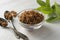 Brown sugar isolated in glass bowl, over styled marble background. Mint leaves. Top view, copy space