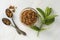 Brown sugar isolated in glass bowl, over styled marble background. Mint leaves. Top view, copy space