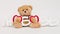 Brown teddy bear with a sing love. Sign Love in Russian. Celebration of Valentine`s day. Love and happiness. Family