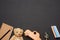 Brown teddy bear, wooden toy car and glass globe on black chalk board, back to school