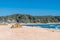 Brown tent pitched on sandy ocean beach