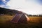 Brown tent with quick installation system. Standing in the rays of the sun on the top of the mountain. Summer, rest, camping