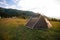 Brown tent with quick installation system. Standing in the rays of the sun on the top of the mountain. Summer, rest, camping. Copy