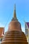 Brown tiled pagoda with blue sky background