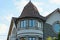 Brown tower and attic of a private house with windows