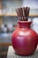 Brown tube in the ceramic red vase