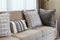 Brown tweed sofa with grey pillows