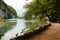 Brown walkway surrounded with water mountains green grass and trees in National Park Plitvice Lakes in Croatia