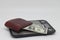 Brown wallet with banknotes on electronic kitchen scales. Symbol of accounting and family finance planning