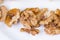 Brown walnuts on white plate