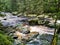 Brown waters of the Vydra river flowing over the stones & x28;Sumava mountains& x29;