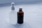 Brown and white bottle on a light fabric background. Amber Glass Pharmaceutical Medicine or Chemical Solvent Bottle