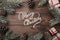 Brown wood background. Fir branches, decorative cones. Message space for Christmas and New Year. Gifts for xmas. Greeting card. Xm