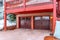 Brown wood doors with glass panes of a two car garage below snowed in balcony