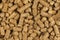 Brown wood pellets texture background. natural pile of wood pellets. organic biofuels. Alternative biofuel from sawdust. The cat