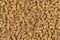 Brown wood pellets texture background. natural pile of wood pellets. organic biofuels. Alternative biofuel from sawdust. The cat