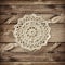 Brown wooden board and small crochet doily