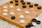 Brown wooden chessboard with classic checkers. Table game. Checkers on the playing field for the game