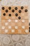 Brown wooden chessboard with classic checkers. Table game. Checkers on the playing field for the game