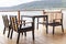 Brown wooden dining table set at seaside terrace