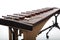 A brown wooden marimba on a white background