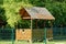 Brown wooden plywood gazebo behind a fence