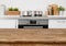 Brown wooden table on defocused pastel color kitchen interior background