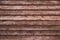 Brown wooden texture at horizontal striped. Dark weathered hardwood. Retro rough oak fence. Old wood plank background. Vintage tex