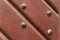 Brown wooden texture with iron rivets and sloping lines background