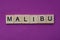 brown word malibu from small wooden letters