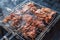 Browned pieces of meat in a metal grill on steaming coals during the preparation of barbecue in the country on May holidays.