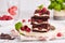 Brownie cake bars with cheesecake layer, dark chocolate and raspberries