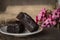 Brownie cake placed on a white plate with The pink flower placed beside it