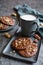 Brownie cookies topped with melted chocolate and chopped peanuts