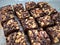 Brownie cubes with chocolate pieces and nuts, top view.Flat lay food