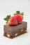 Brownie desert with strawberries on top.