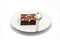 The brownie on white dish with a spoon for ready to serve