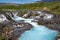 Bruarfoss waterfall on a sunny day in summer. Features beautiful teal turquoise water in Iceland along the Golden Circle area