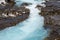 Bruarfoss waterfall on a sunny day in summer. Features beautiful teal turquoise water in Iceland along the Golden Circle area.