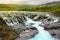 Bruarfoss waterfall with turquoise water cascades at sunset, Ice