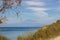 Brucoli view of sea through vegetation of tree and grass, blue sea and sky with far Etna