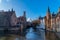 Bruges, Belgium 02/29/2020. Spring scenery with gothic style houses of Sint-Janshospitaal and water canal in medieval belgian city