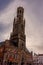 Bruges, Belgium - 17 February 2018: Belfry of Bruges, a group of people walking in front of a clock tower with Belfry of Bruges in