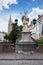 Bruges, Belgium - August 16, 2013: Statue of Johannes Nepomucenus and the church tower against the blue sky in Bruges