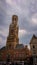 Bruges, Belgium - May 12, 2018: Tourists And Locals Walk On A Sunny Day On Main Square. In Background View To Provincial Court