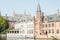 Bruges, Belgium. Medieval ancient houses made of old bricks at water channel with boats in old town. Picturesque landscape