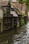 Bruges, Belgium. Medieval ancient houses made of old bricks at water channel in old town. Picturesque landscape.