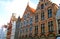 Bruges, Brugge, facades of ancient houses of an unusual shape against the blue sky, ancient architecture,