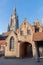 Bruges - Church of Our Lady from yard of Saint John Hospital (Sint Janshospitaal) in evening